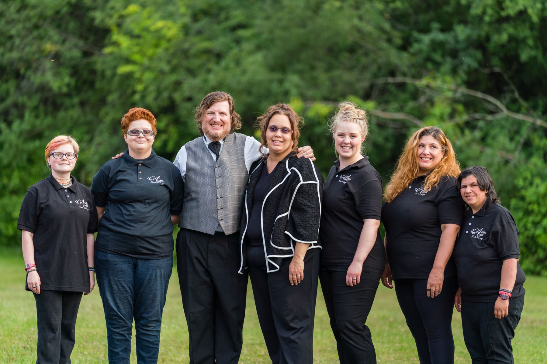 A group of women standing in the grass.