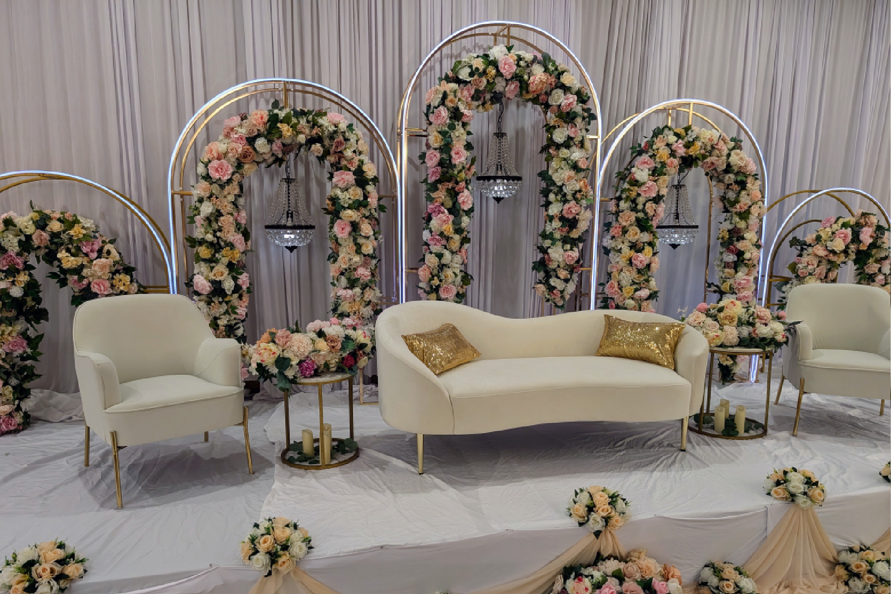 A room with flowers and white furniture